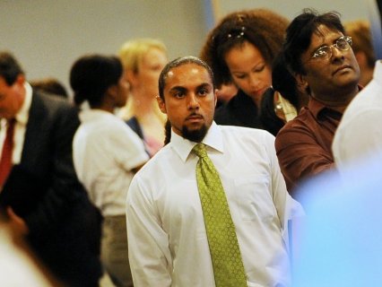 Job seekers wait in line to